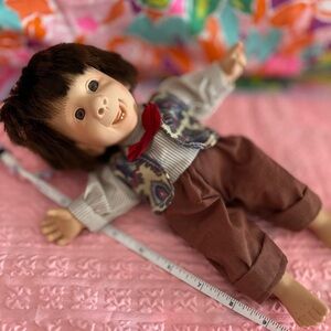 Adorable Brown-Haired Doll with Red Bow Tie